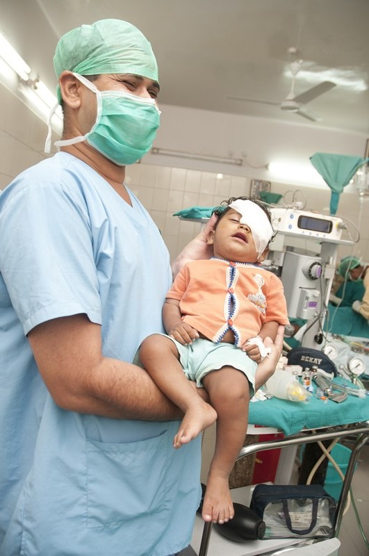 Assistant holding child cataract patient.jpg